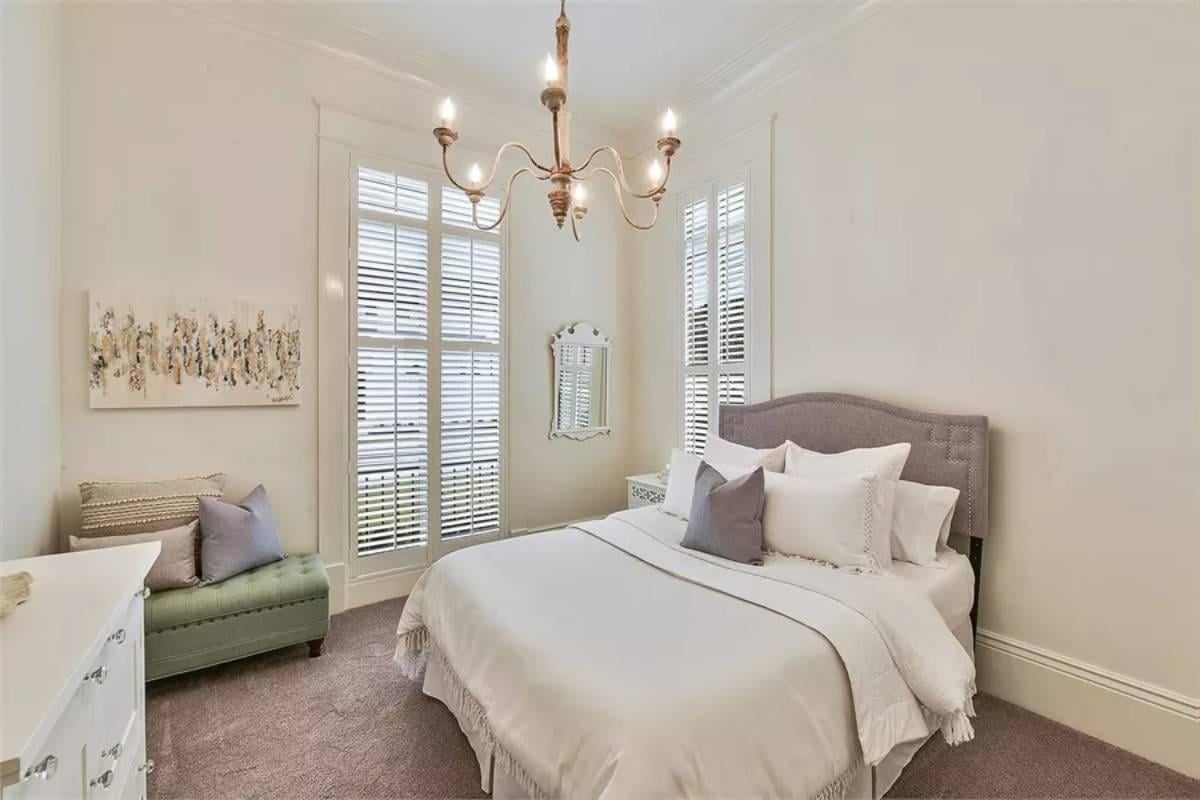 Elegant Bedroom with a Classic Chandelier and Subtle Texture