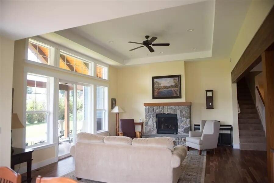 Craftsman Living Room with a Stone Fireplace and Tray Ceiling