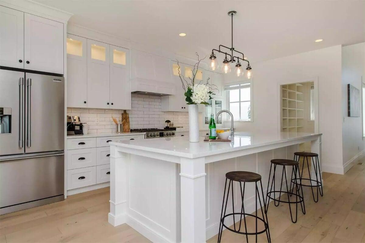 Check Out the Sleek White Island Against the Subway Tile Backsplash