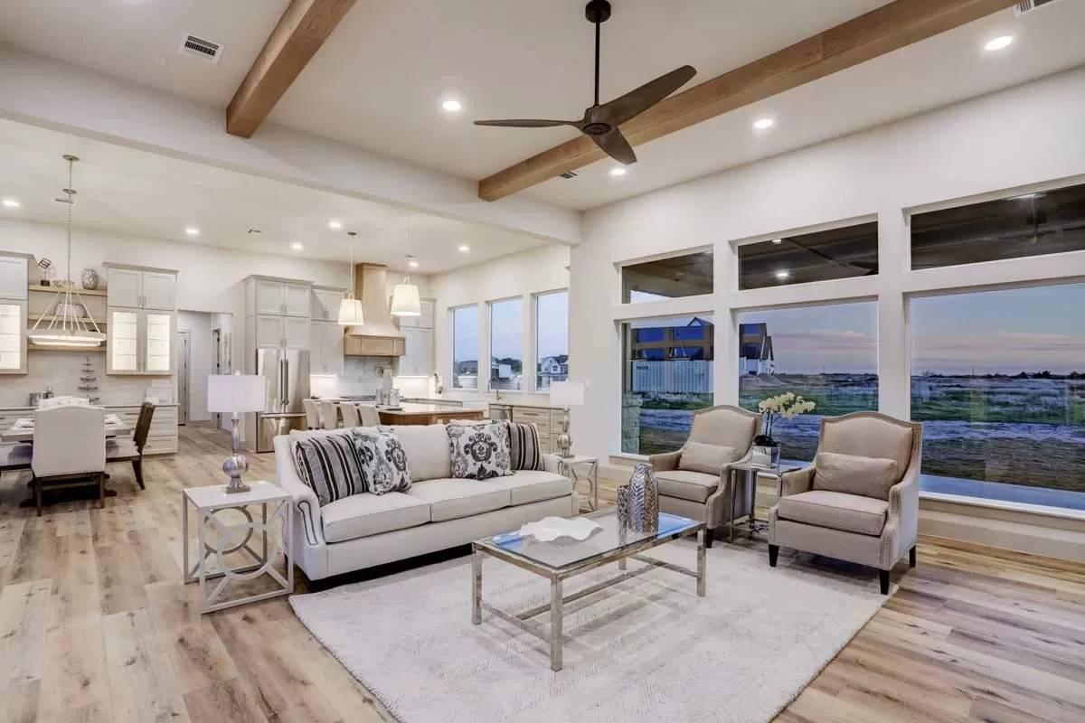 Open-Concept Living Room with Wood Beam Accents and Panoramic Windows