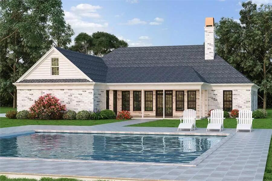 Classic Poolside View with a Charming Whitewashed Brick Exterior
