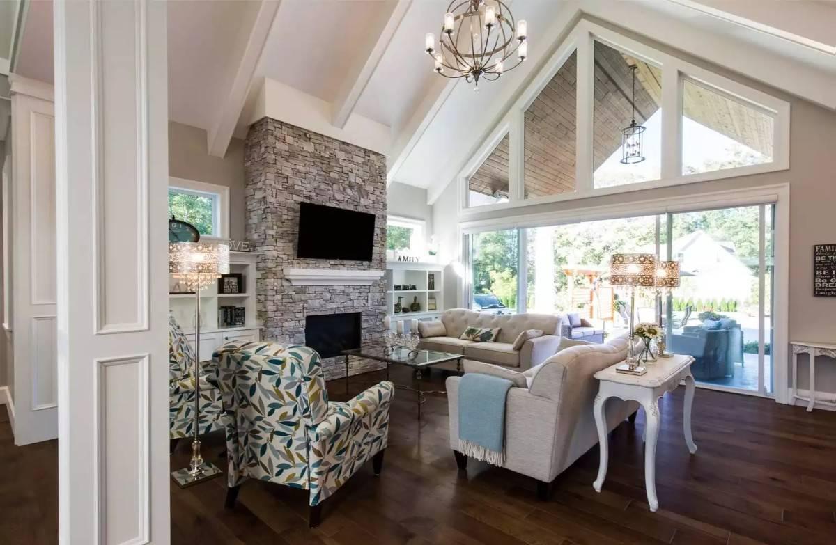 Soak in the Vaulted Ceiling and Stone Fireplace in This Living Room