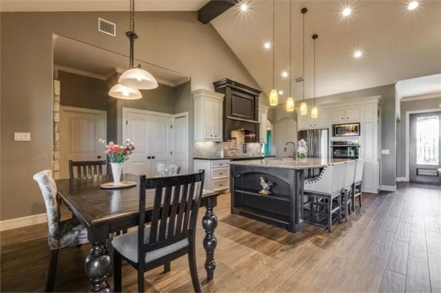 Distinctive Kitchen with Dark Cabinetry and Vibrant Pendant Lights