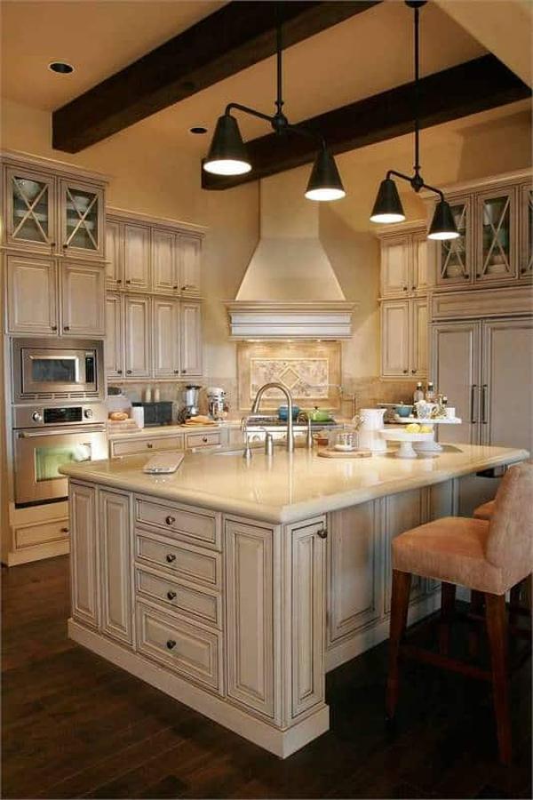 Elegant Kitchen Featuring a Dramatic Beam and Marble Island