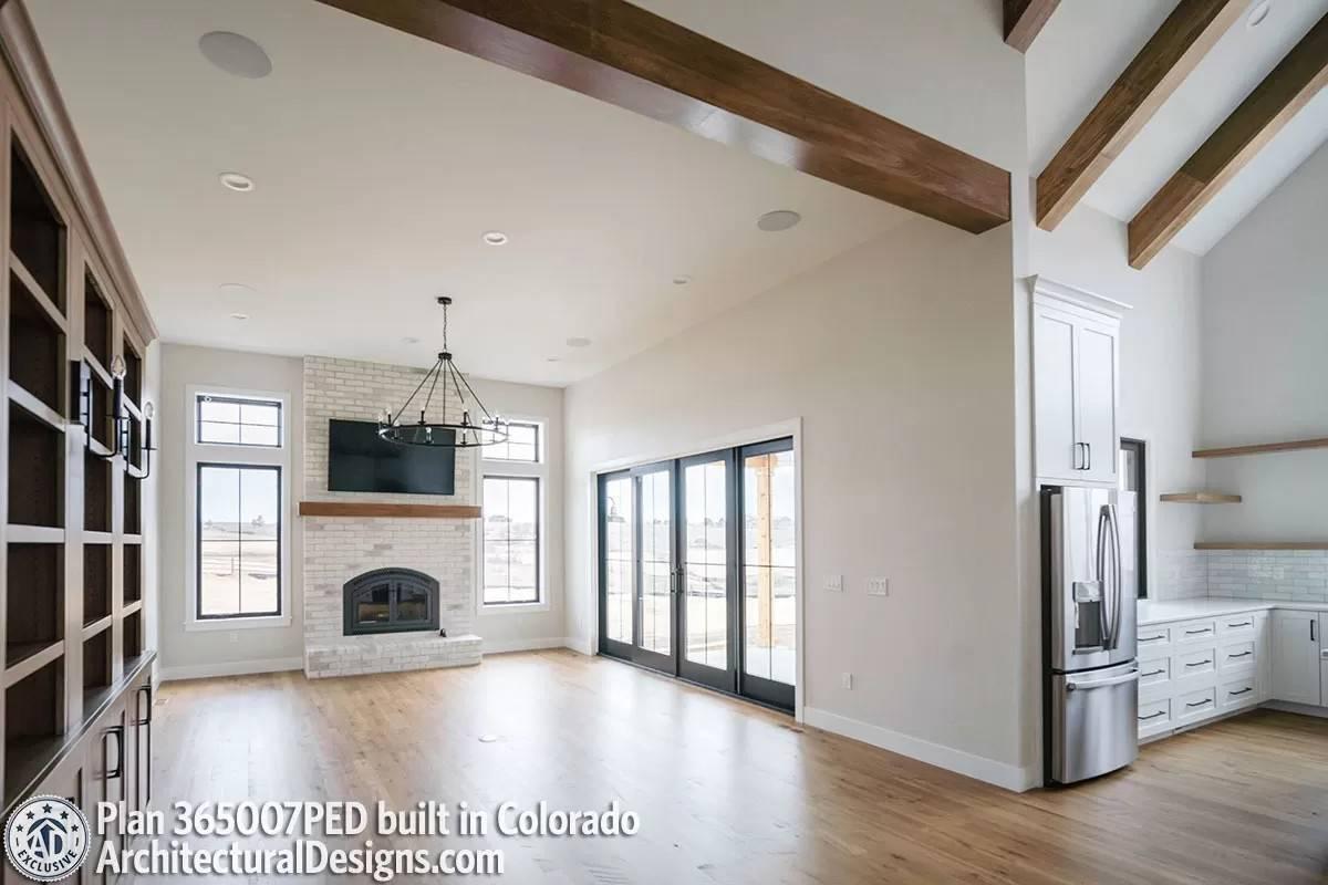 Check Out the Soaring Ceilings and Brick Fireplace in This Spacious Living Room