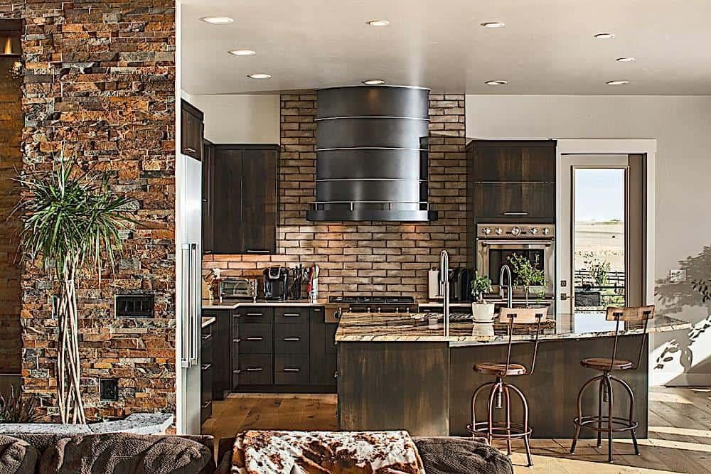 Rustic Kitchen with Striking Brick Wall and Sleek Metal Range Hood