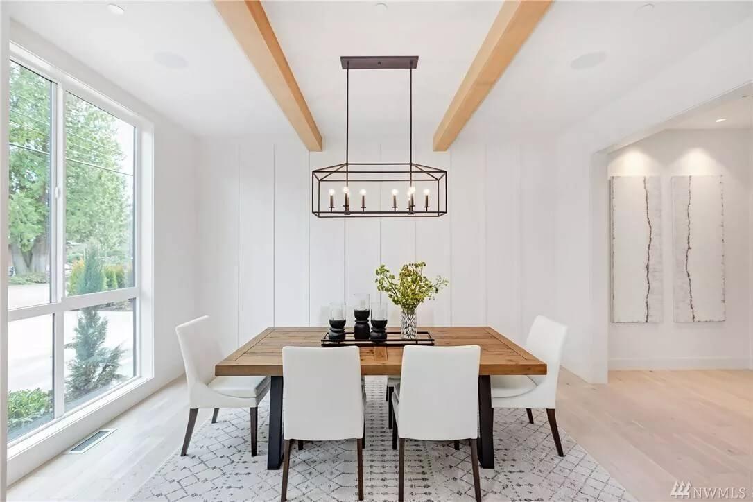 Dining Room with Exposed Beams and a Bold Light Fixture
