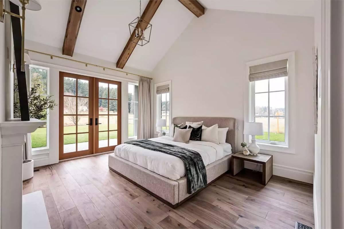 Notice the Expansive French Doors and Exposed Beams in This Serene Bedroom