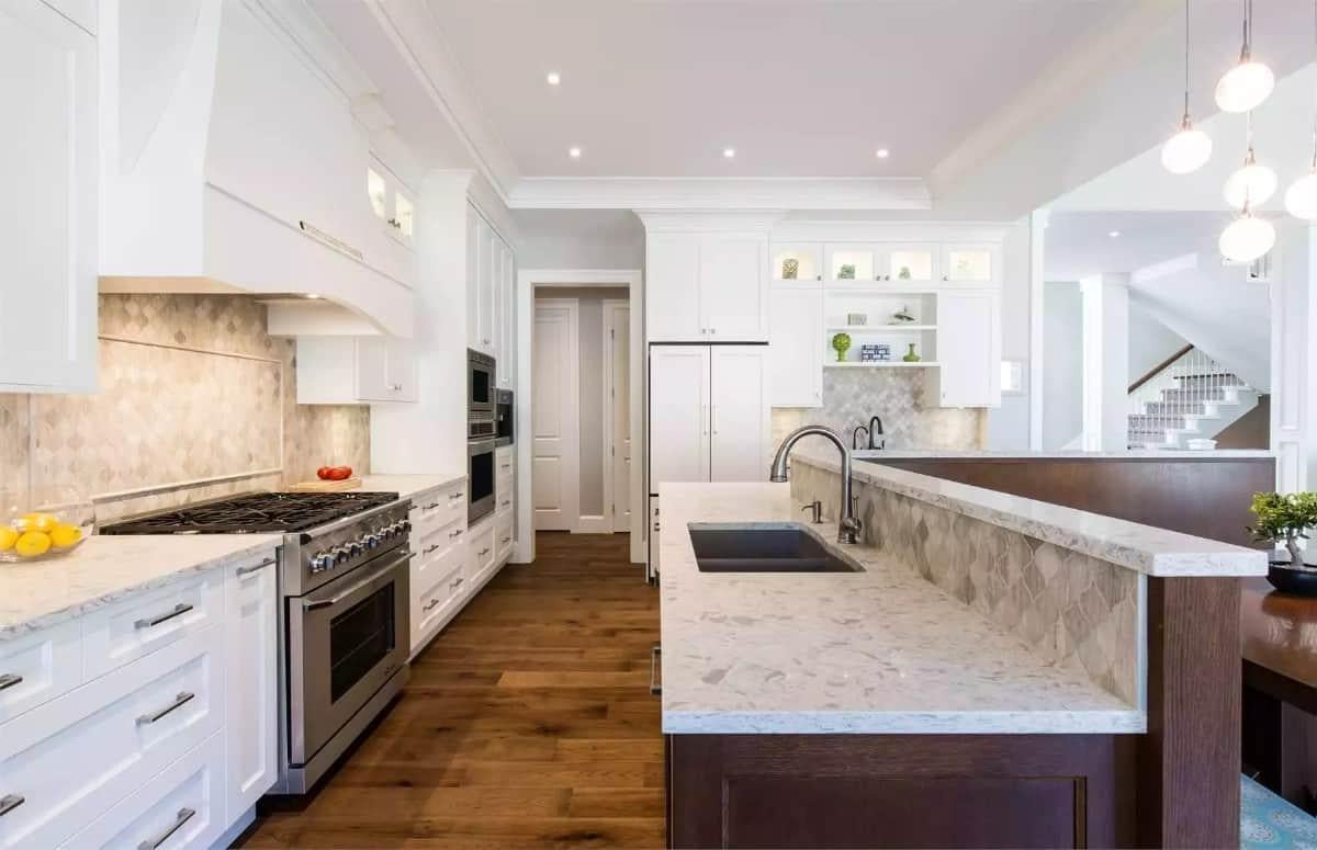 Check Out the Marble Countertops and Elegant White Cabinetry in This Kitchen