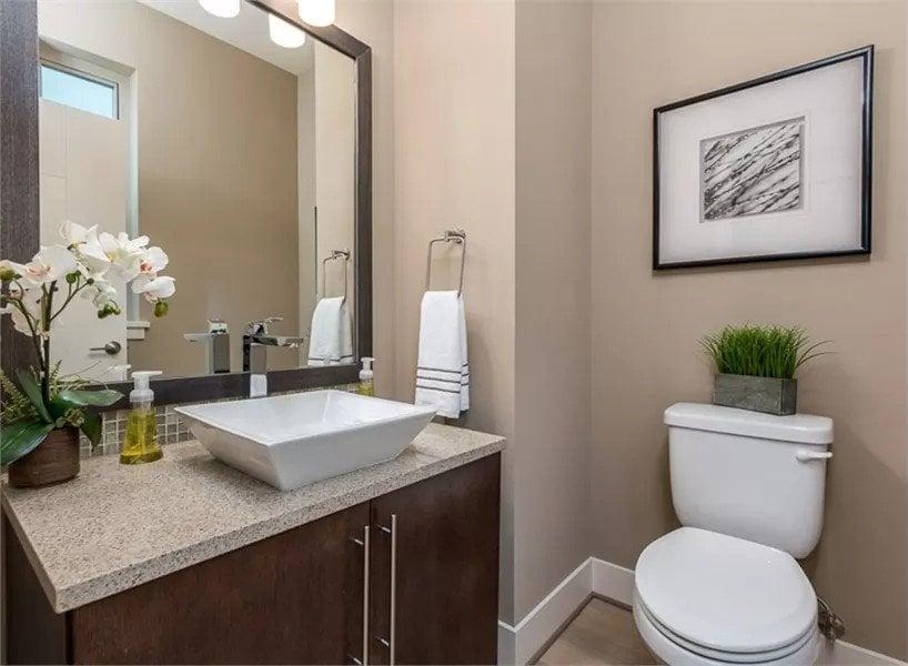 Notice the Vessel Sink and Thoughtful Decor in This Modern Powder Room