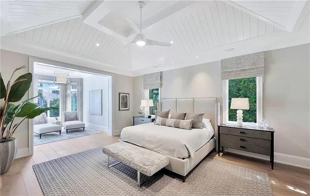 Notice the Vaulted Ceiling and Elegant Sitting Area in This Bedroom