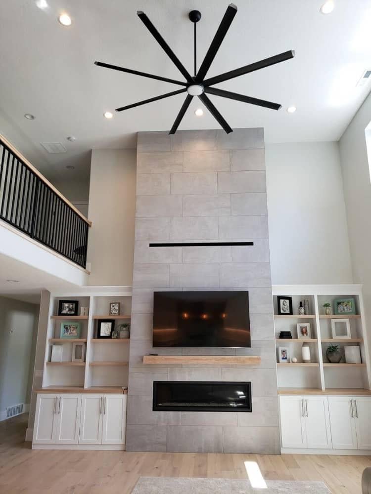 Admire the Vertical Fireplace Wall and Sculptural Fan in This Great Room