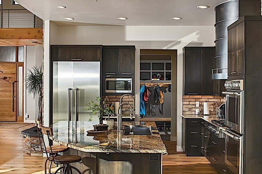Check Out the Granite Island and Metal Range Hood in This Craftsman Kitchen