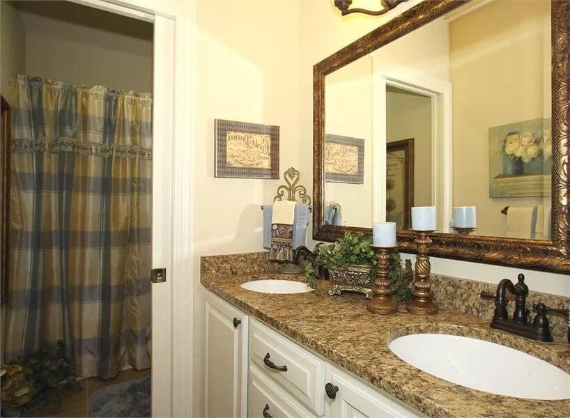 Admire the Ornate Framed Mirror in This Elegant Bathroom