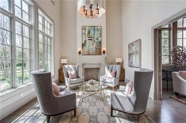 Sunlit Sitting Room with Tall Windows and a Stylish Chandelier