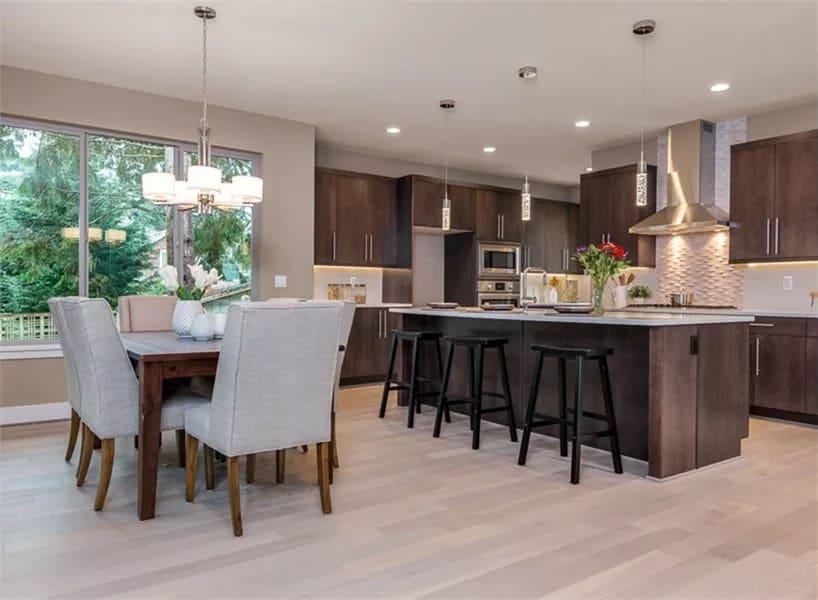 You Have to See the Spacious Island in This Sleek Kitchen and Dining Area