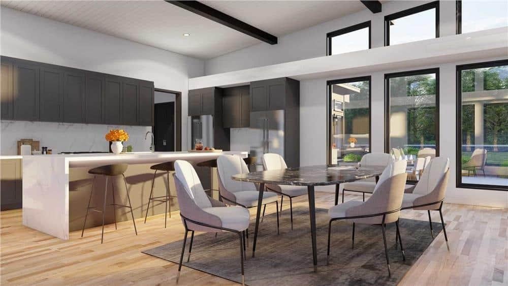 Explore This Modern Kitchen and Dining Combo with Large Windows and Black Cabinets