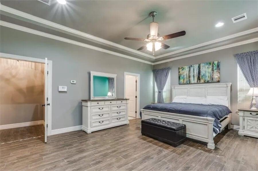 Elegant Bedroom with Eye-Catching Tray Ceiling and Modern Fan