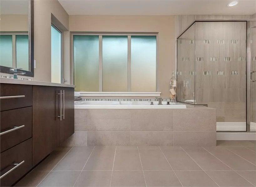 Modern Spa-Like Master Bathroom Featuring a Frosted Glass Window