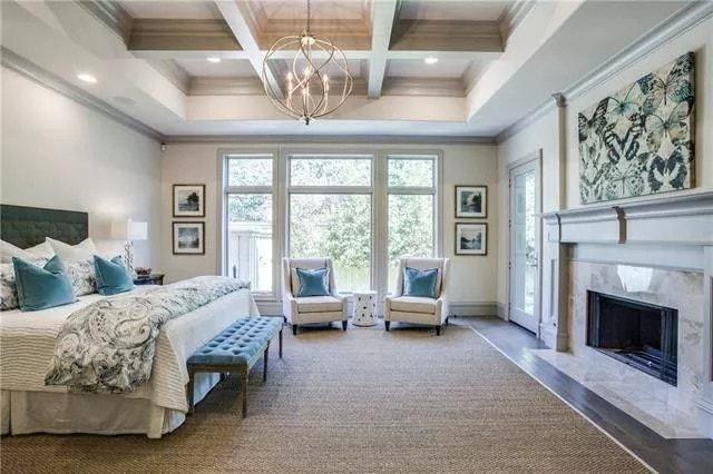 Master Bedroom with a Striking Chandelier and Luxurious Tray Ceiling