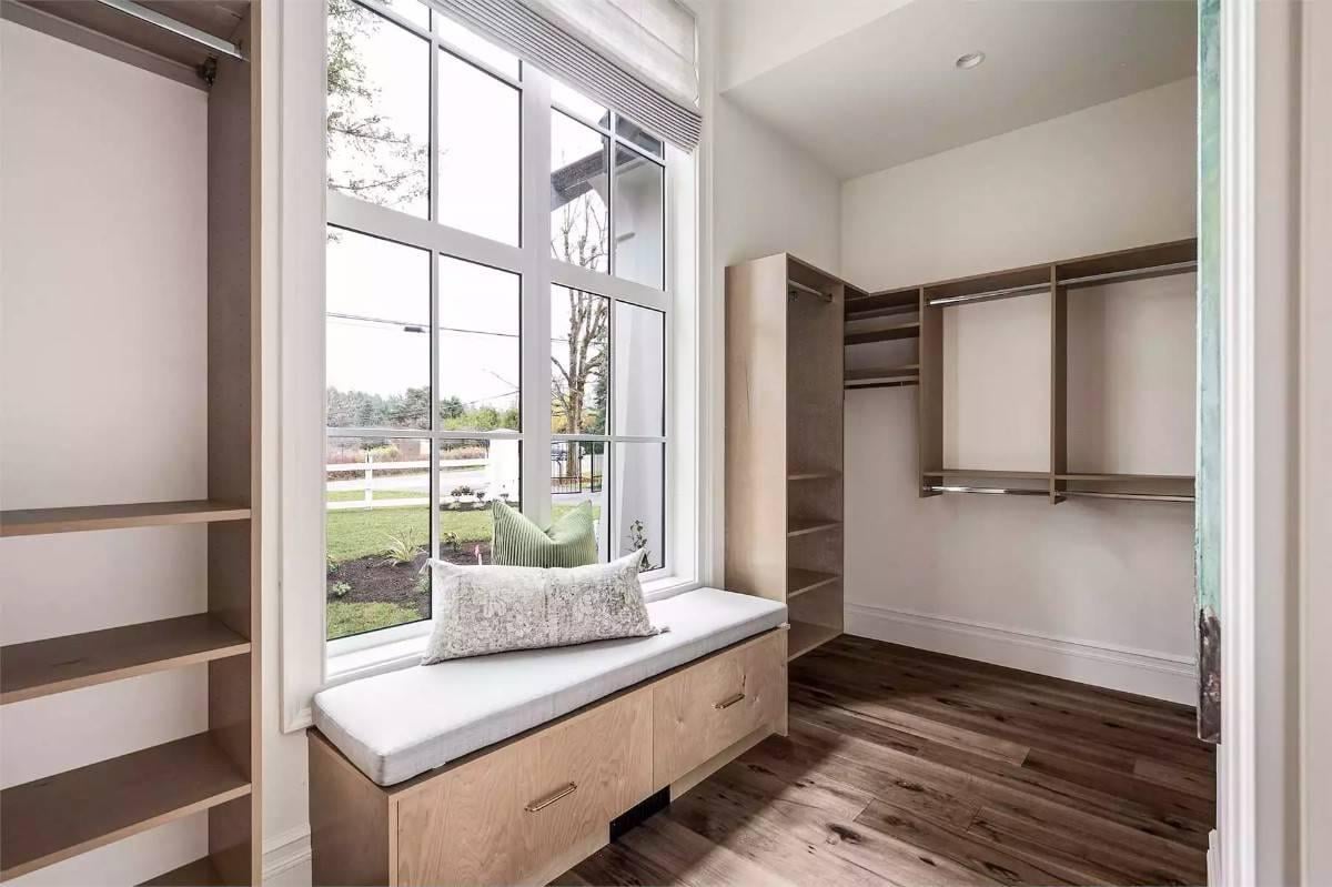 Check Out the Cozy Window Seat in This Stylish Walk-In Closet