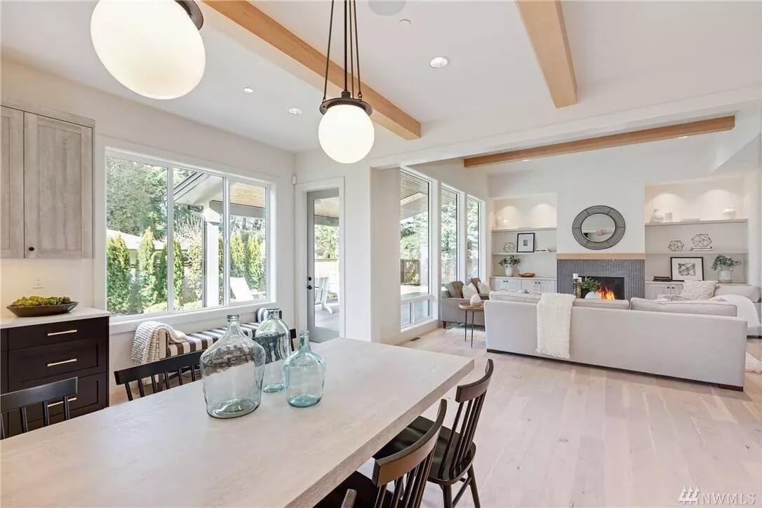 Bright Open Living Area with Exposed Wooden Beams and Glass Decor