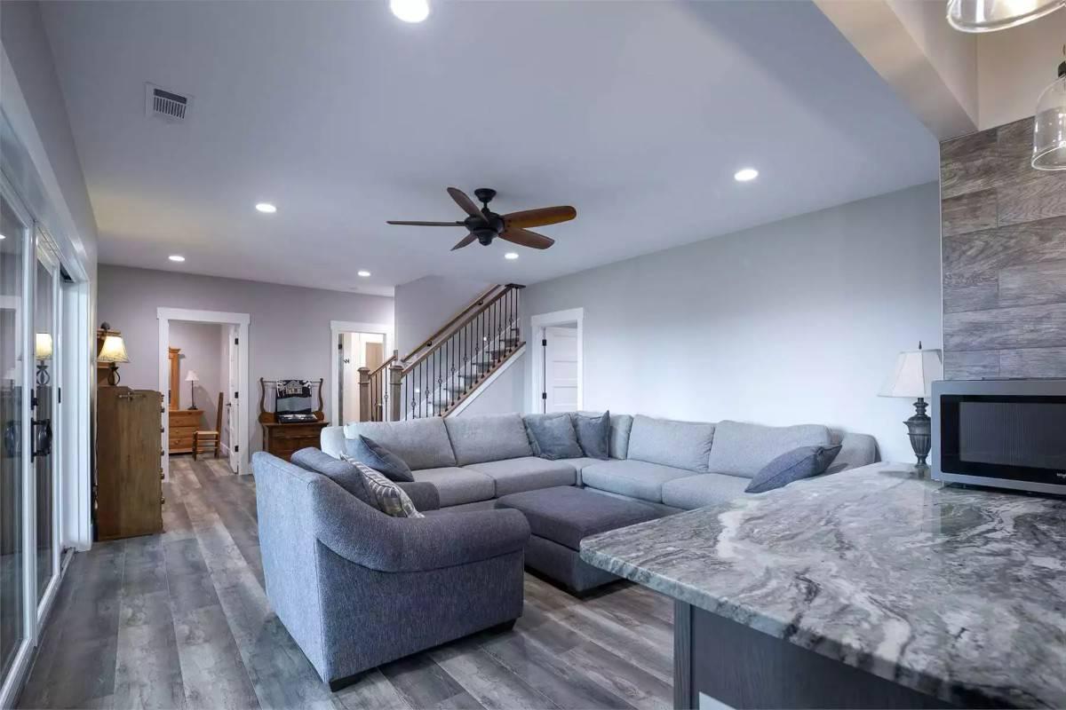 Comfy Family Room with a Large Sectional and Marble Countertop Details