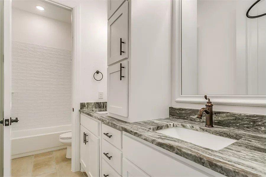 Notice the Striking Granite Countertops in This Bathroom Design