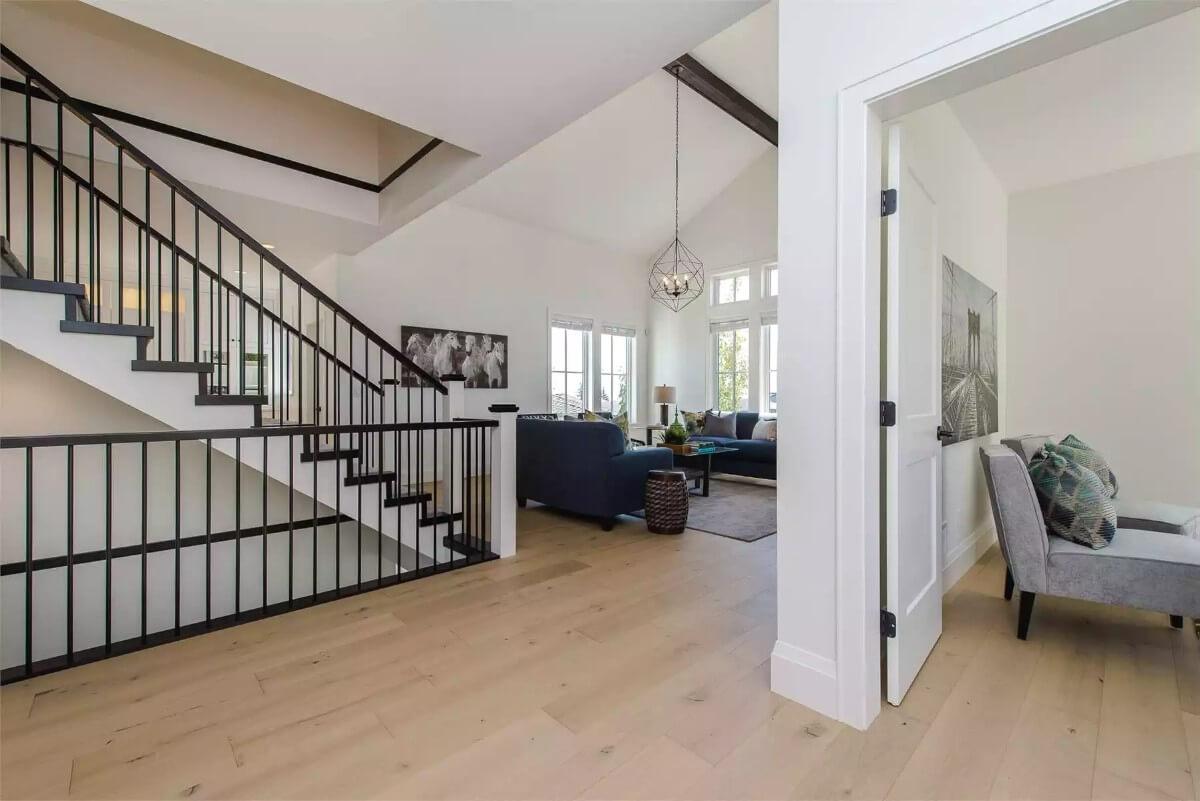 Modern Staircase with Bold Black Accents and Open Living Area
