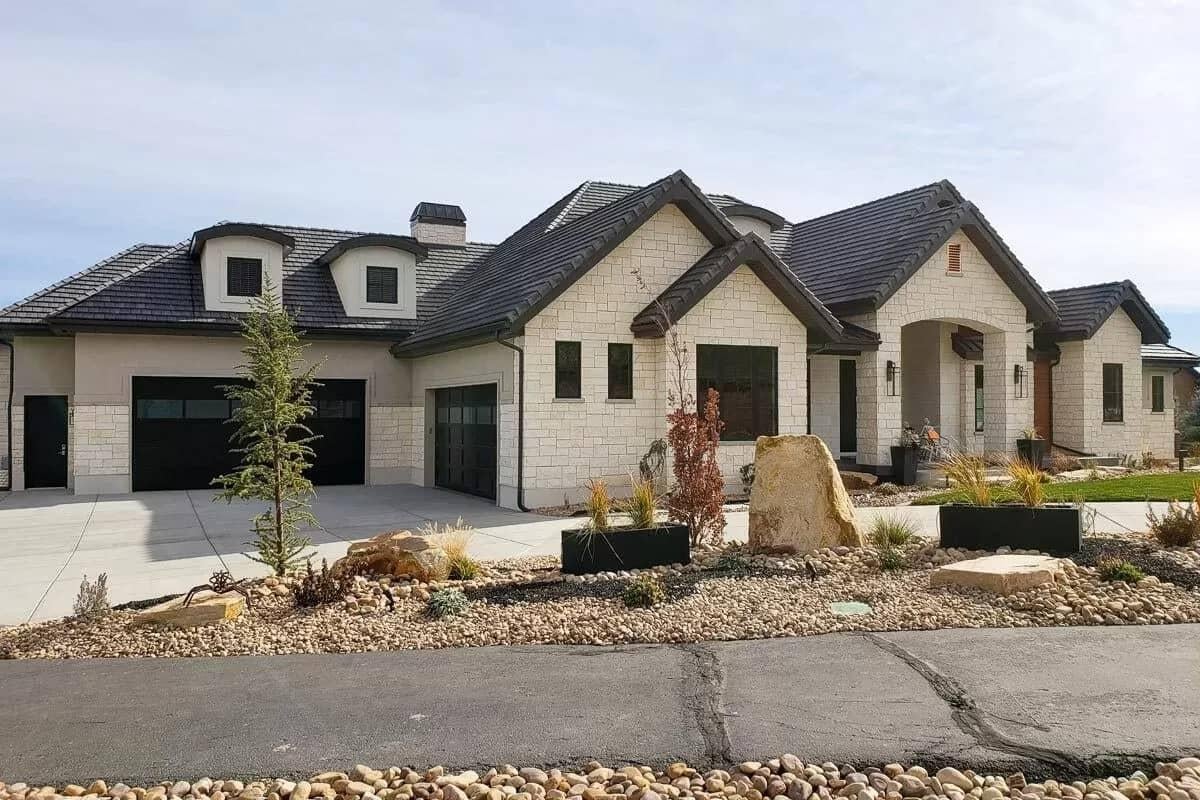 Admire the Contrasting Stone and Stucco Facade with Twin Dormers