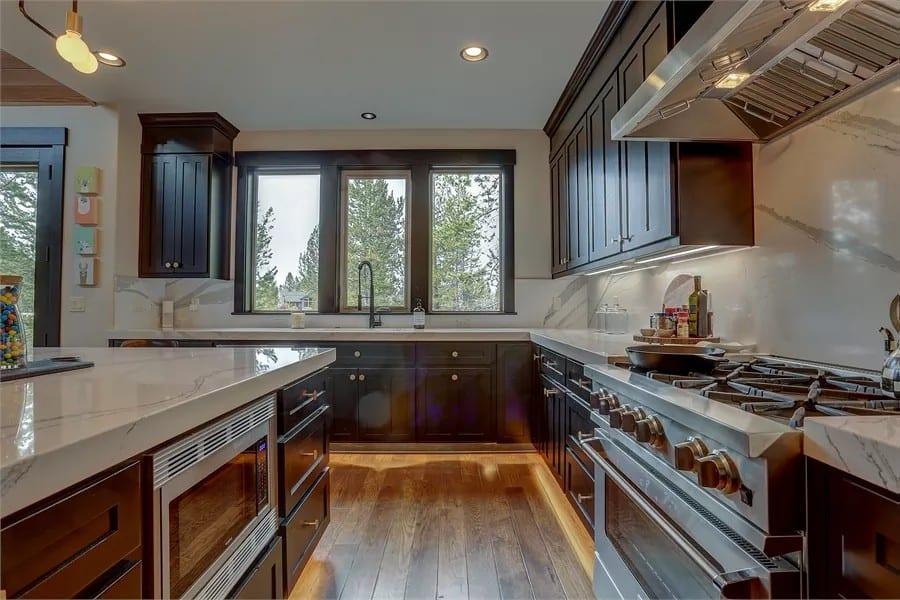 Bright Kitchen Featuring Bold Dark Cabinetry and Modern Fixtures