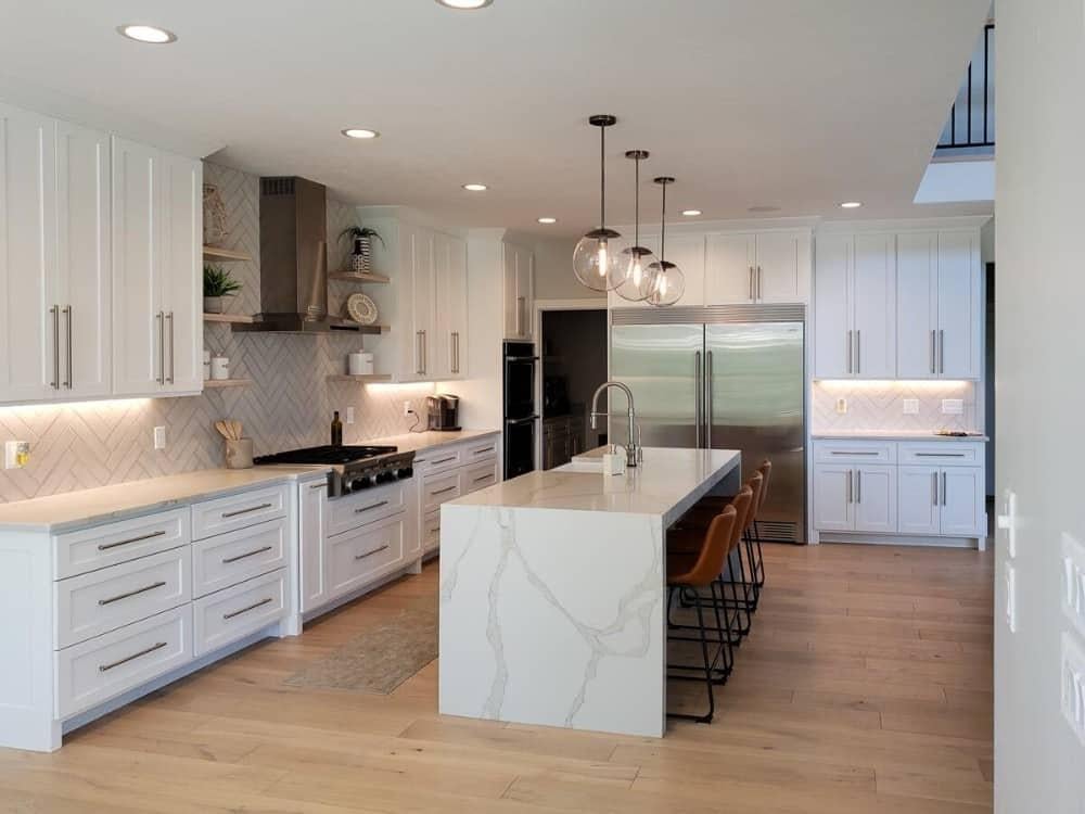 Check Out the Elegant Waterfall Island and Subtle Under-Cabinet Lighting