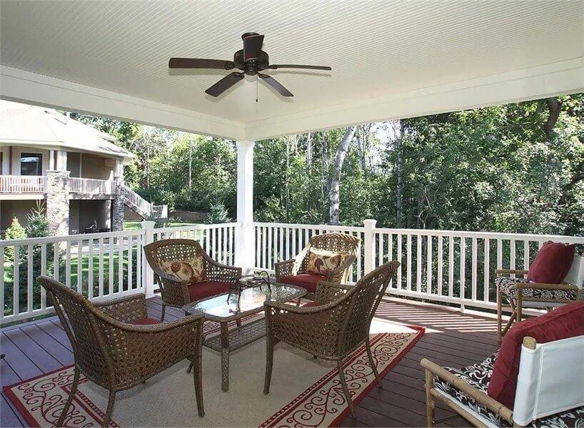 Relax on This Spacious Porch with Woven Furniture and Ceiling Fan