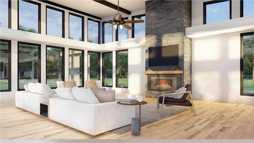 Light-Filled Living Room with Towering Clerestory Windows and a Central Stone Fireplace