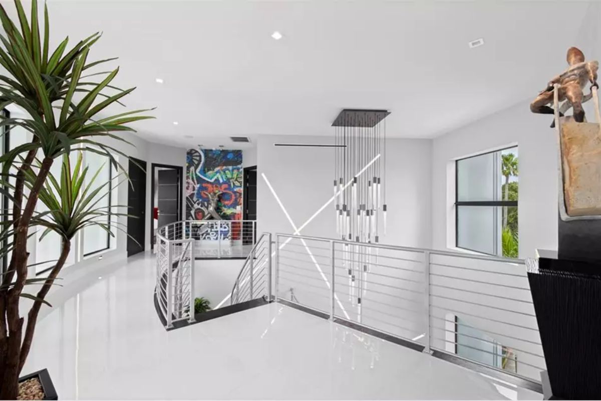 Landing area includes sleek cable railing and high-gloss white flooring.