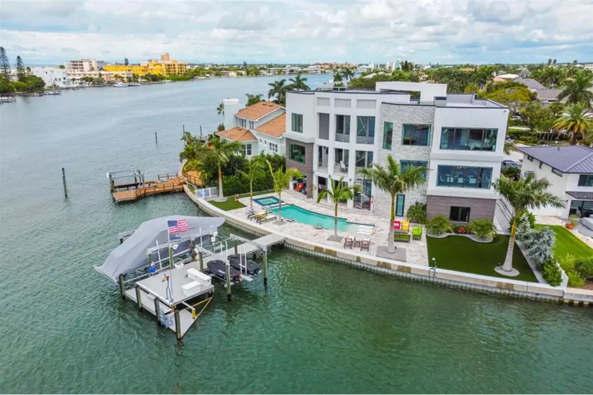 Home sits on a point lot surrounded by a seawall and water on three sides. 