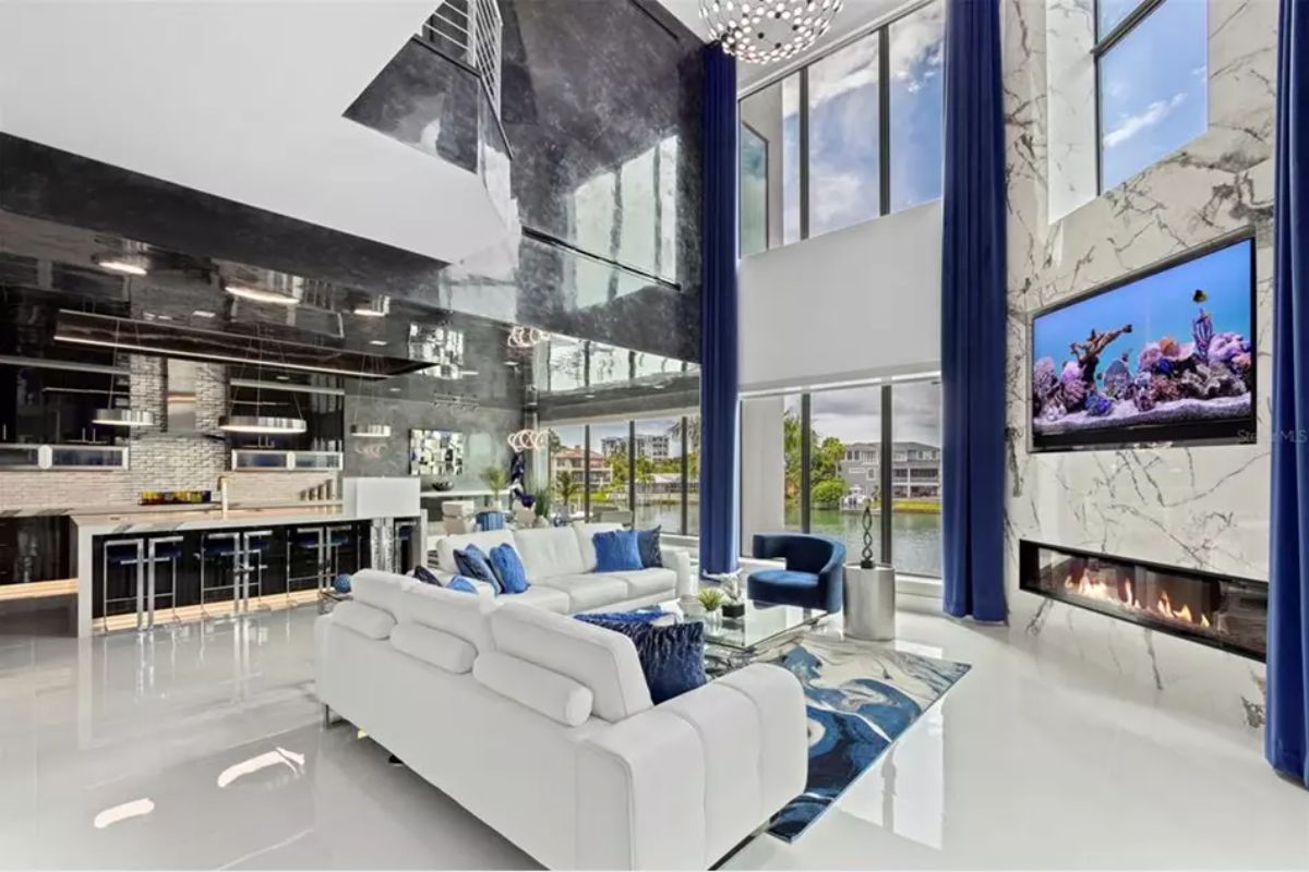 Living area has a high-gloss black ceiling and large marble fireplace wall.