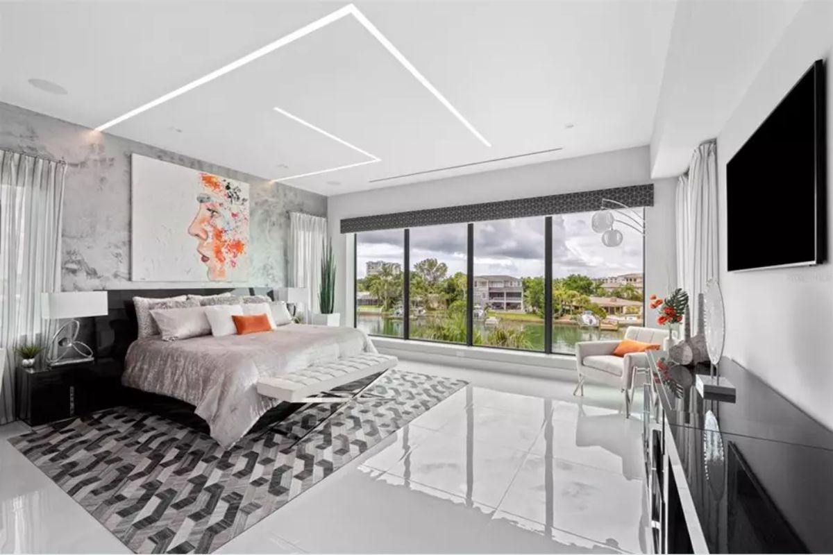 Room includes a platform bed facing a large picture window.
