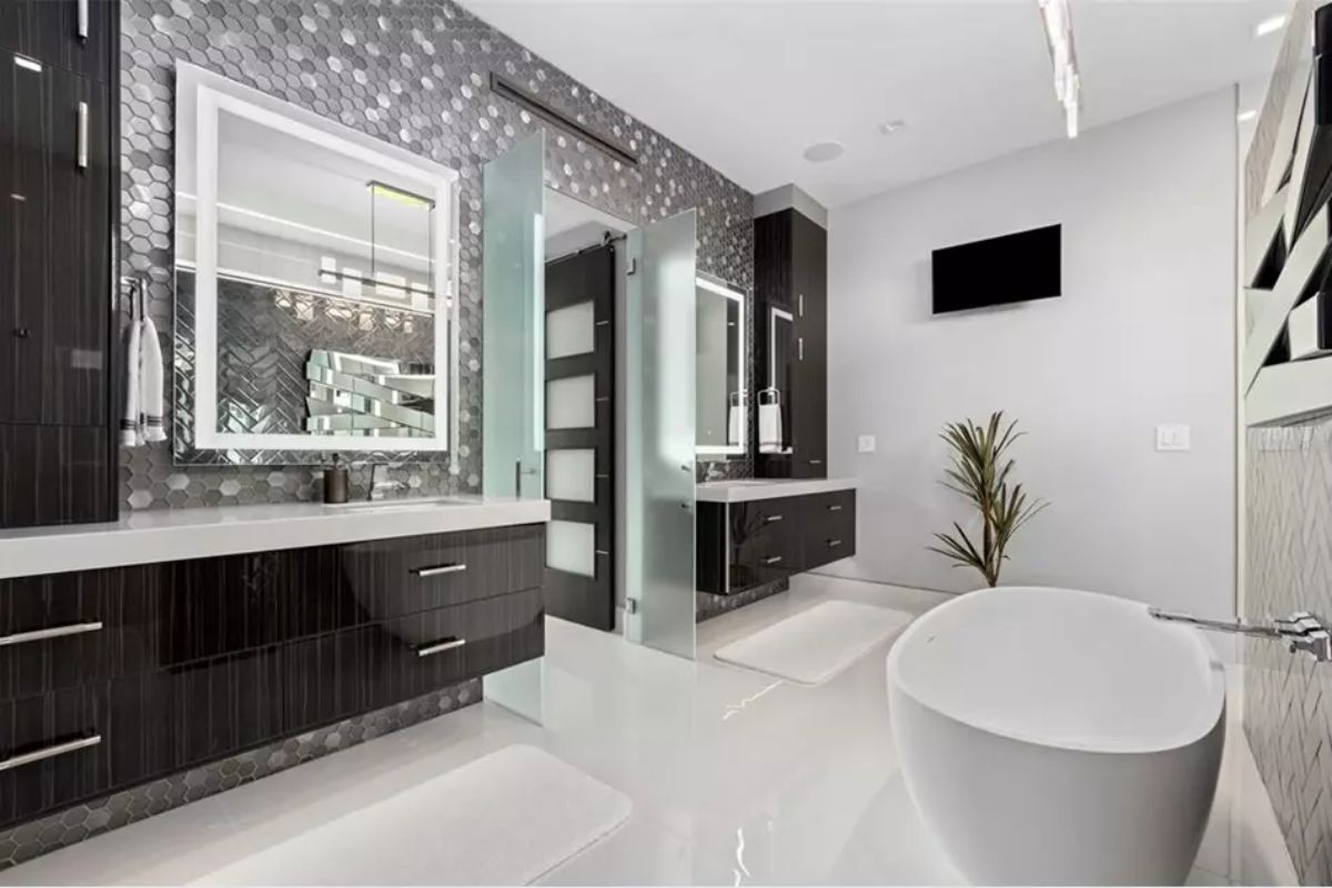 Sleek bathroom with glossy white floors, floating dark wood vanities,
