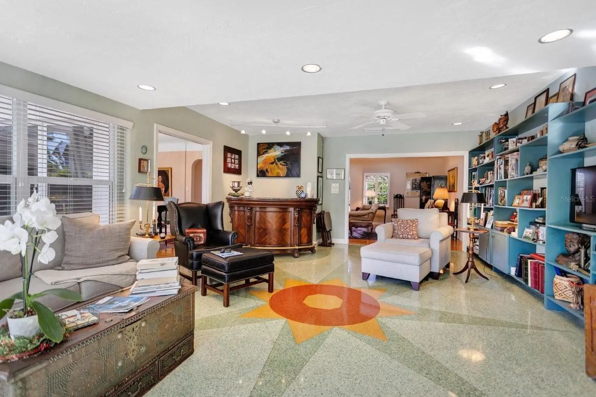 Eclectic space features a bold sunburst design embedded in the terrazzo floor.