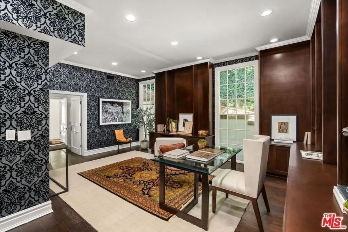 Stylish home office with dark wood paneling, sophisticated wallpaper, and a classic design. 