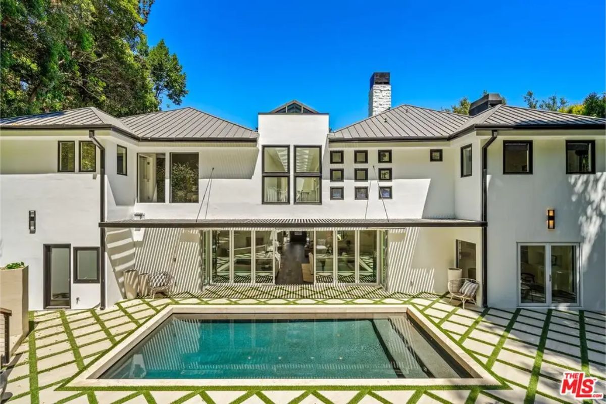 Stunning backyard with a geometric pool, lush landscaping, and a private retreat feel. 