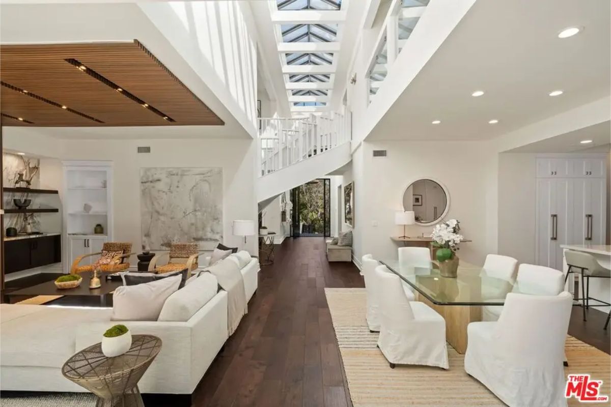 Spacious lounge area with a skylight ceiling, elegant seating, and contemporary design elements. 