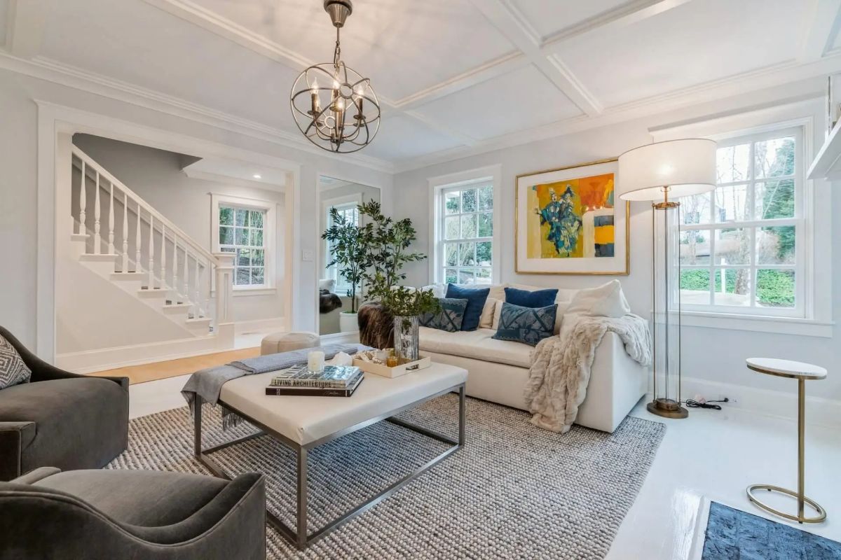 White coffered ceiling and soft neutral walls frame the open layout.