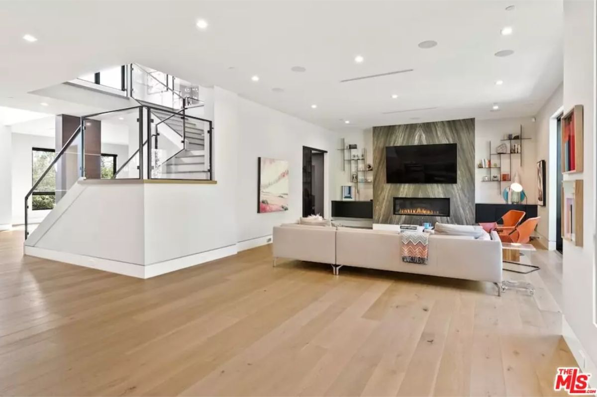 Open-concept living space showcases a media wall with elegant marble accents. 