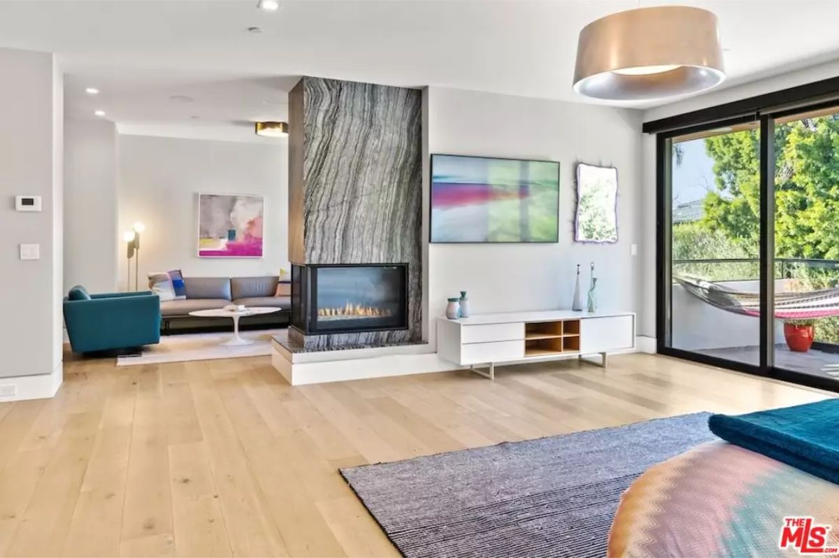 Cozy master suite with a double-sided fireplace connecting to a lounge area. 