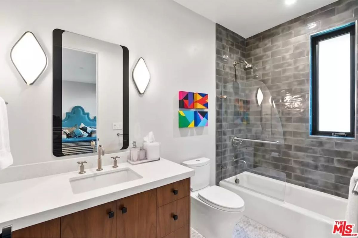 Chic bathroom with a floating vanity, modern fixtures, and a subway tile backsplash. 