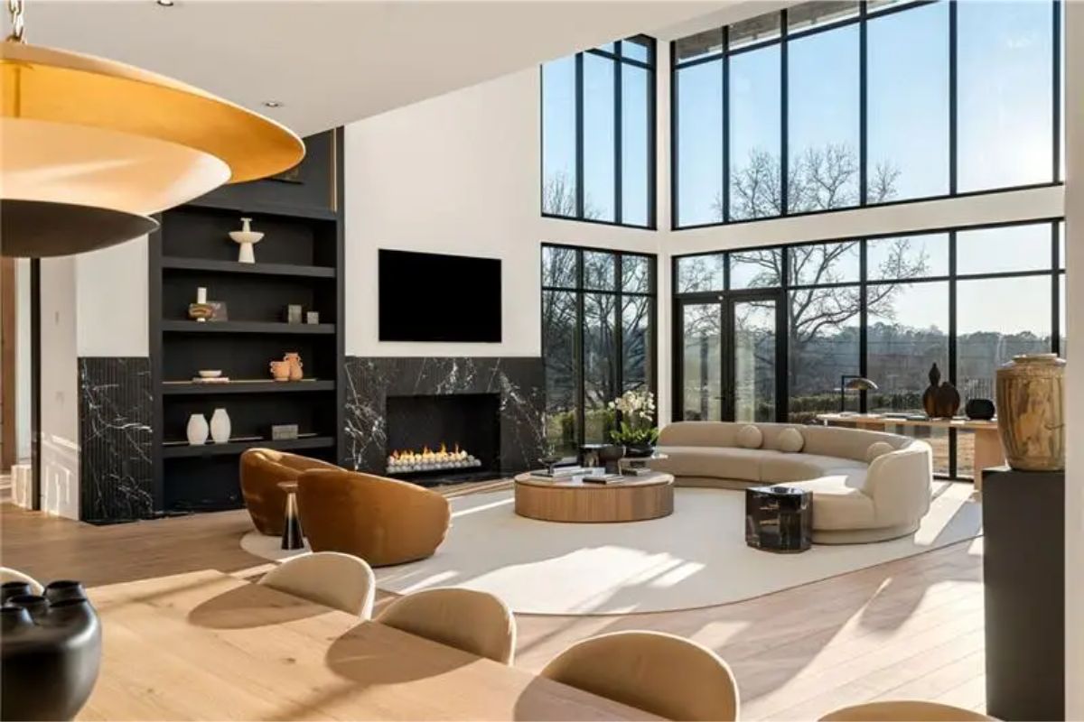 The same living area, now viewed from another angle, highlights a built-in fireplace and cozy seating arrangement. 