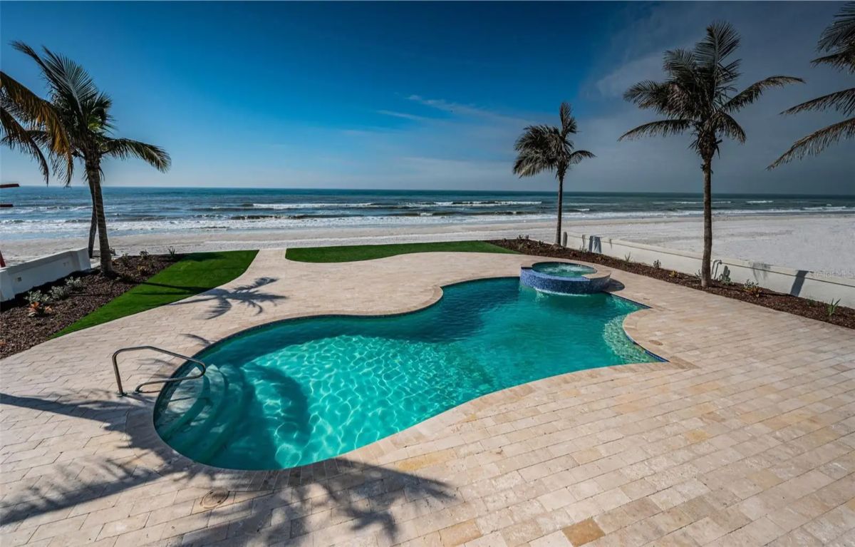 Backyard has a custom-shaped pool with integrated spa.