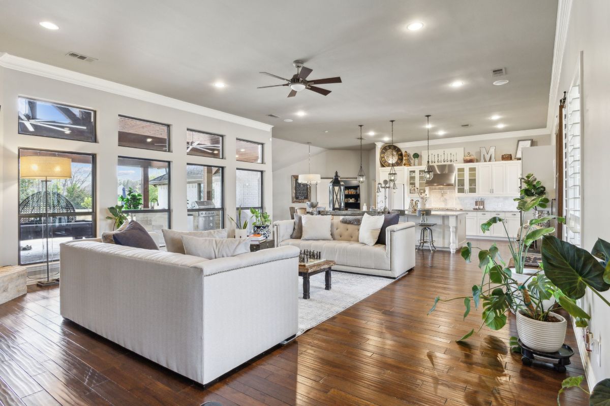 Living area flows into the kitchen with wood floors throughout.